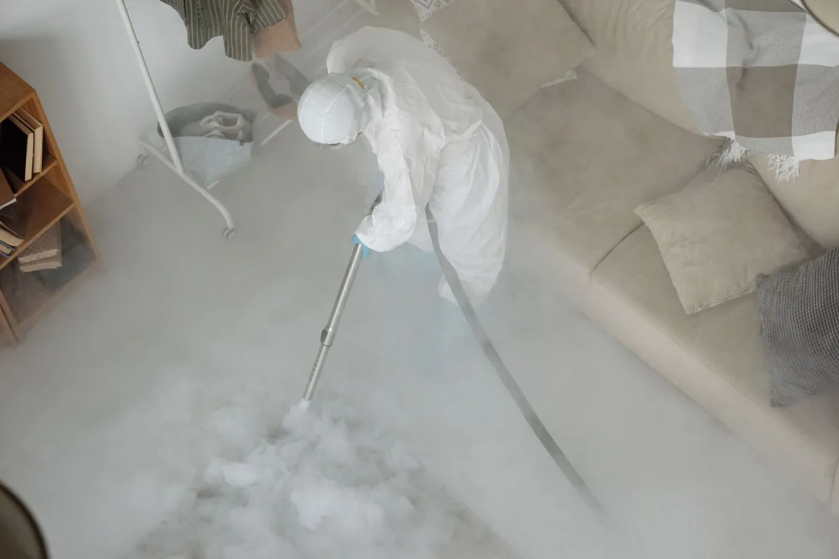 Biohazard cleanup technician in protective equipment, Buckner, MO